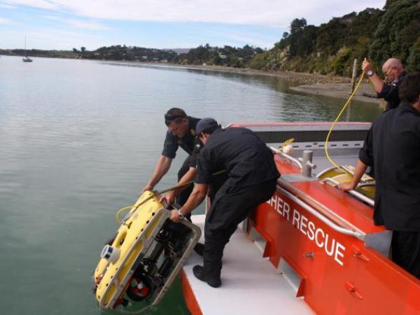 Navy personnel load mission critical equipment on to a Raglan Coastguard vessel in March