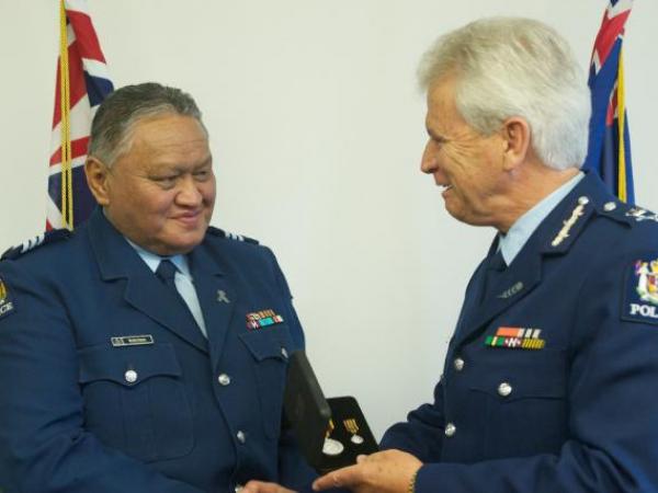 Commissioner Peter Marshall presents the Meritorious Service Medal to Sergeant Wayne Panapa