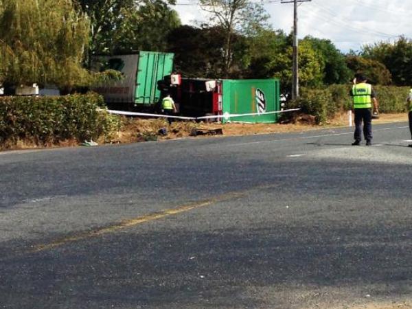 Police crash investigators inspect the scene of this afternoon's fatal crash