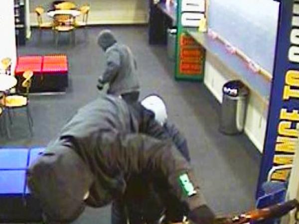 Frightening: An armed robber mounts the TAB's counter