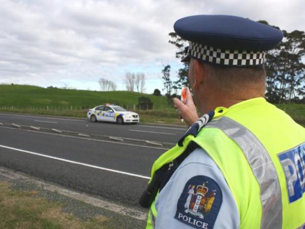 Sgt Neil Mansill points to a section of wire rope barrier which stopped a car crossing the centreline on SH1