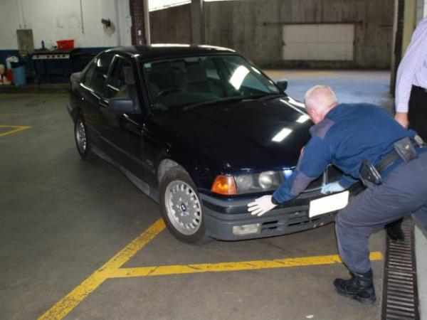 Police moving the recovered car into the examination bay