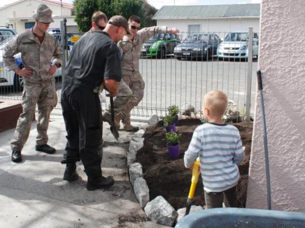 Soldiers and a police officer receive an extra pair of helping hands