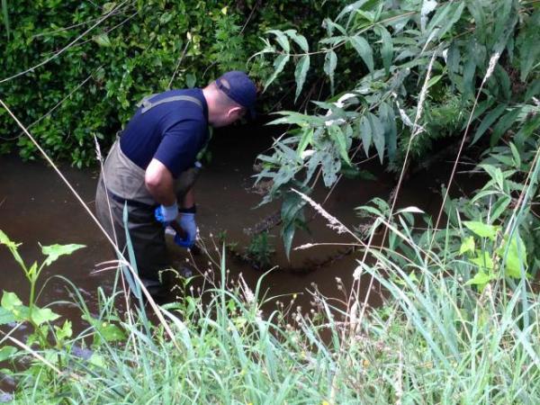Police searching the area near where Friday's murder occurred describe the terrain as challenging