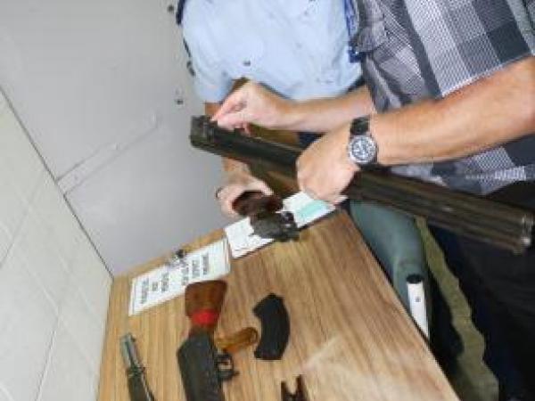 Arms Officer Richard Plas checks serial numbers with Constable Maree Fouhy