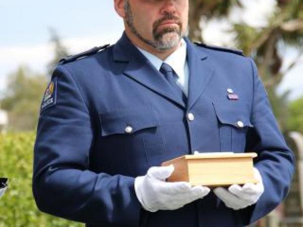 Constable Craig Bennett holds the final remains of Jessie Marguerite Fendall, which were reunited with her body on Friday.