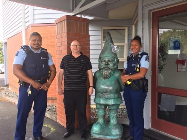 Constable Iosefo Pasina (left), a Salvation Army staff member, and Constable Ngametua Meti with the recovered gnome statue