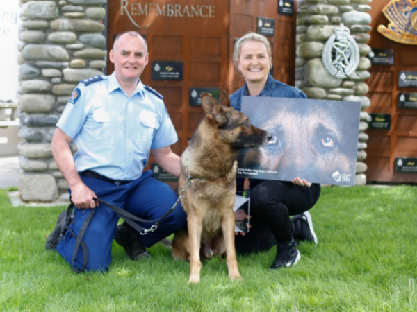 Police dog Arlo gives his seal of approval as Inspector Todd Southall presents Constable Jane Dunn her award