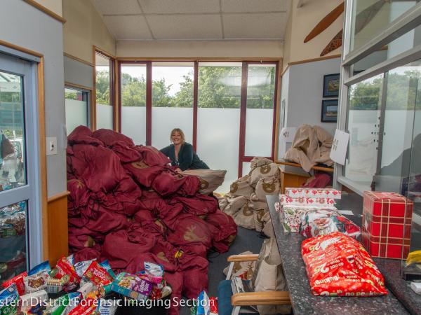 Police Wellness Advisor organising the hoard of gifts in Santa sacks