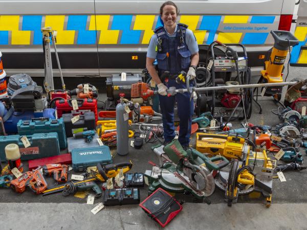 Constable Erin Doherty with some of the stolen tools recovered on Wednesday