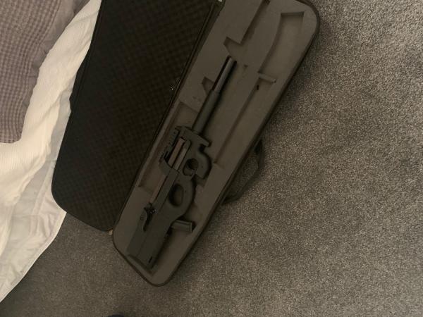 A prohibited firearm in a black case which was recovered during a search warrant. 