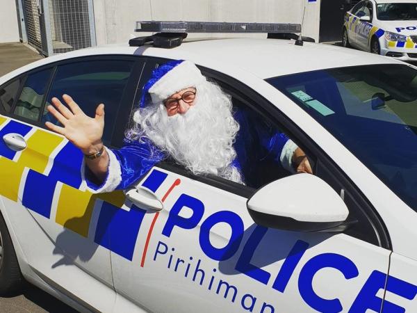 Blue Santa driving a police car