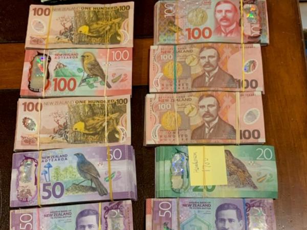 More than $100,000 in cash was located at one address during search warrants
