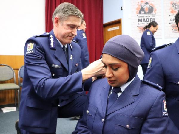 Constable Ali receives her epaulettes after attestation in November 2020 from Commissioner of Police, Andrew Coster.