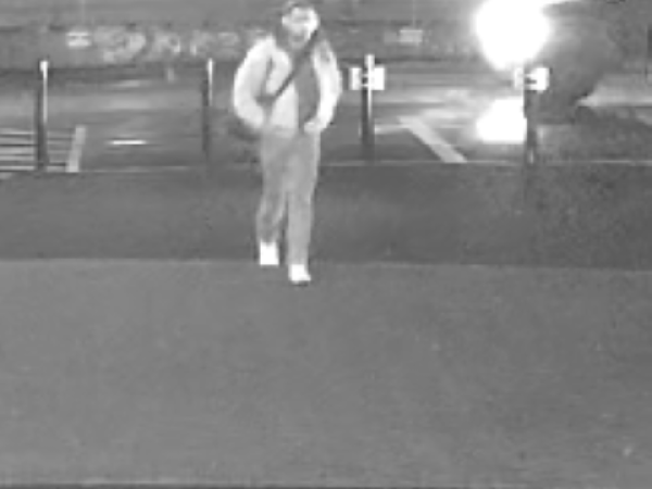 Man walking past Wesley Methodist Church car park
