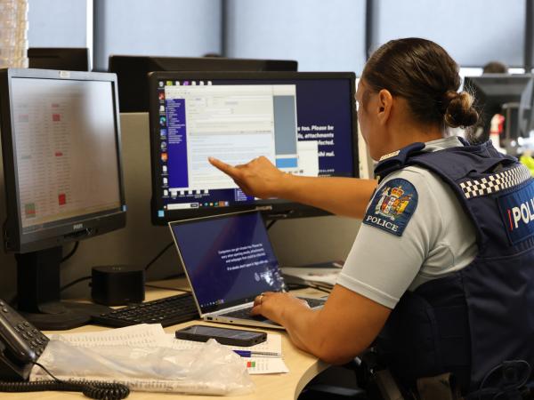 Police officer preparing to make enquiries to locate people