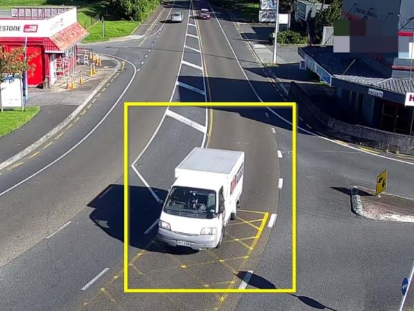 White 2003 Nissan Vanette (light van).