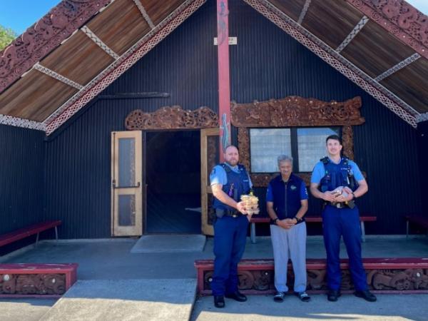 Constable Mitch Maine, Constable Evan McLean giving koha to kaumatua Dennis Rangi