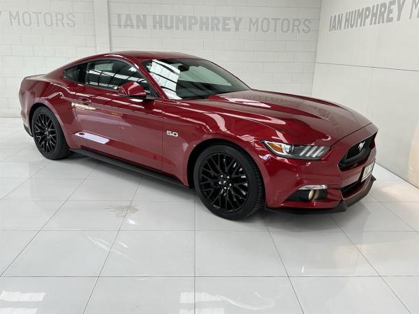 A red 2016 Ford Mustang GT 5.0 model displaying the Registration plate JWL201.
