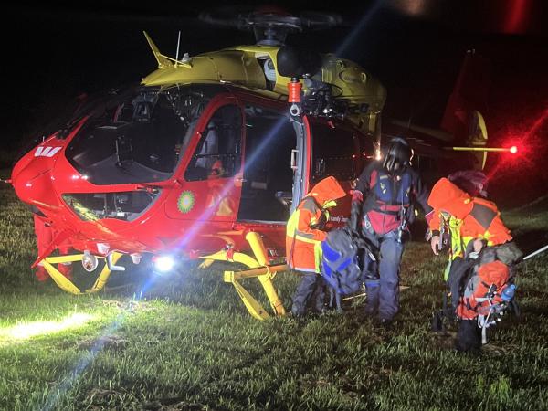 Search and Rescue personnel exiting heli