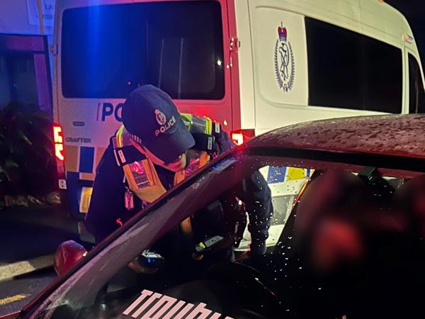 An officer speaks to a driver during a Police operation in Lower Hutt. 
