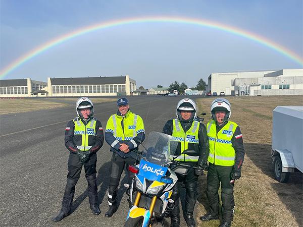 Police motorcycle riders with their bikes standing under a rainbow during a recent re-certification test at Wigram Air Base.
