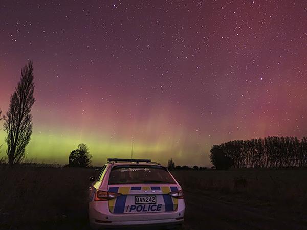Aurora at Green Park, near Lincoln, with back of a police car in the forefront. 