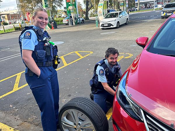 Constable Scott changing the tyre with Constable Caitlin on hand to help.