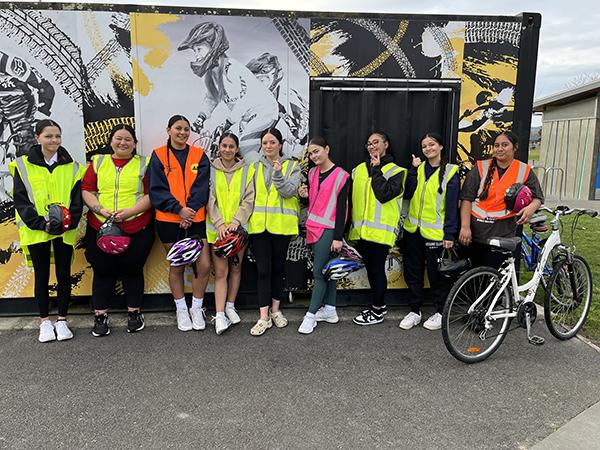 Students in high vis with their bikes