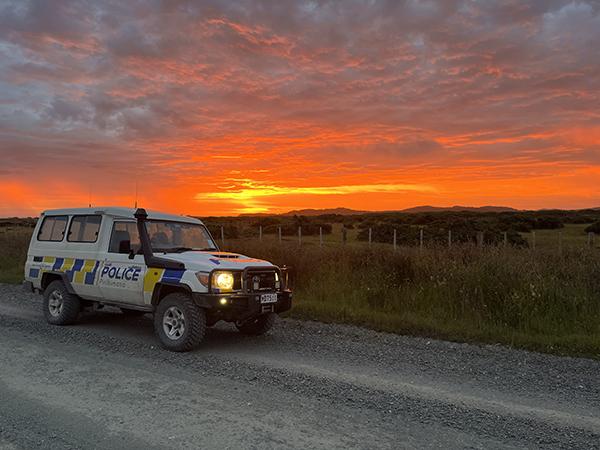 Police vehicle with vibrant sunset in the background on the Chatham Islands