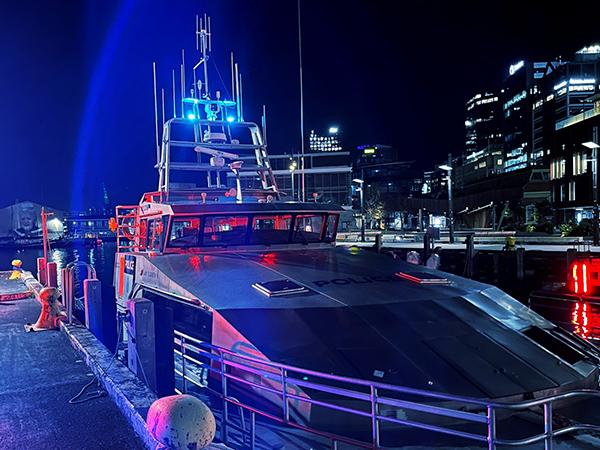 The Lady Elizabeth IV Police maritime boat, bathed in blue light.