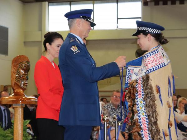 A proud moment for Constable Renine Stansloski as she receives the RNZPC korowai in the presence of the Prime Minister.