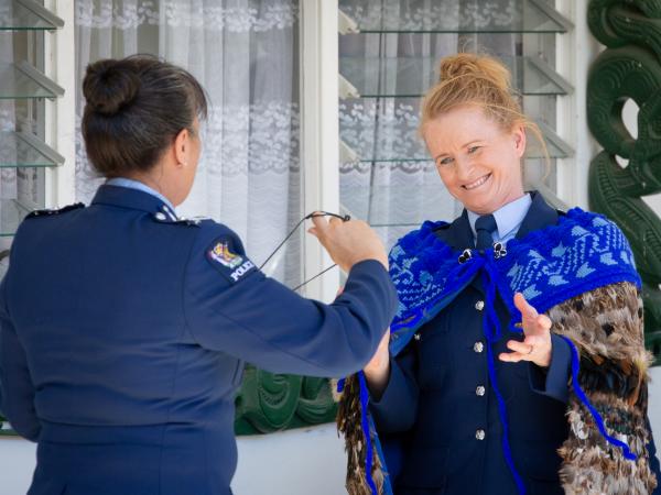 A special moment as Deputy Commissioner Tania Kura hands over the Pounamu Taonga 'Te Matua o te Ika' to Superintendent Jeanette 