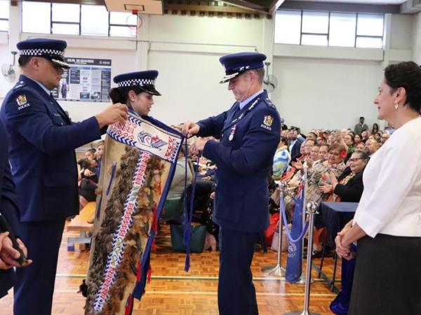 A proud moment for Constable Alice Ander as she receives the RNZPC korowai from Commissioner Andrew Coster.