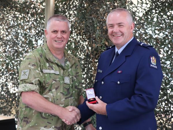 Bruce receiving his commendation from the Chief of Army (CA), Major-General John Boswell.