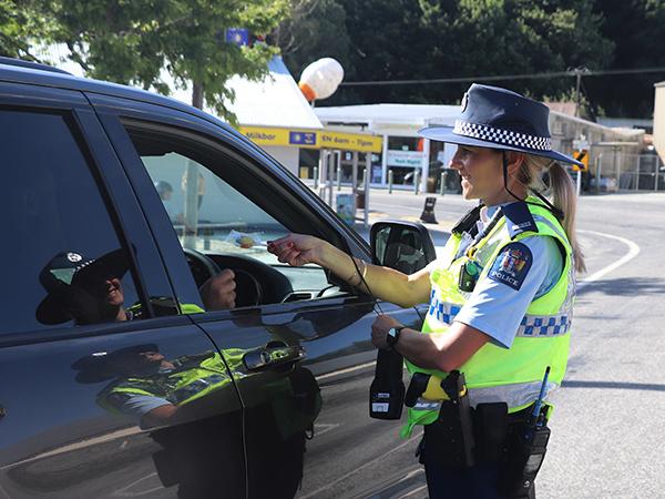 Acting Sergeant Heidi Cunningham  at the Lawrence checkpoint handing out treats