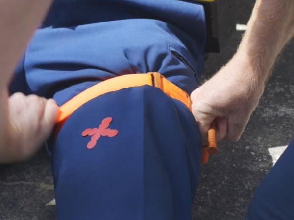 Showing how the tourniquet can be used on a leg.