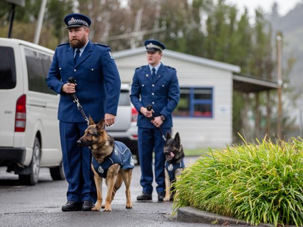 Constable Andrew Smart (left) with Talon and Constable Scott Gosnell with Apex on graduation day.