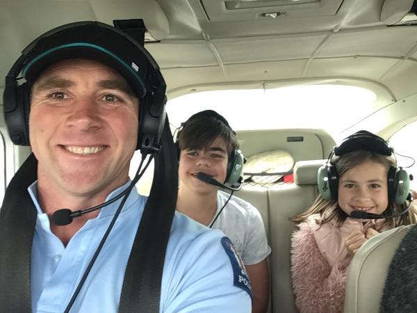 Allan and two very excited children enjoying the flying experience.