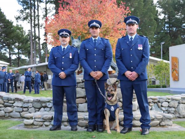 Constable Moses Gunn and Helo flanked by Sergeant Brett Marley (left), their Wellington Dog Section trainer, and Sergeant Blair 