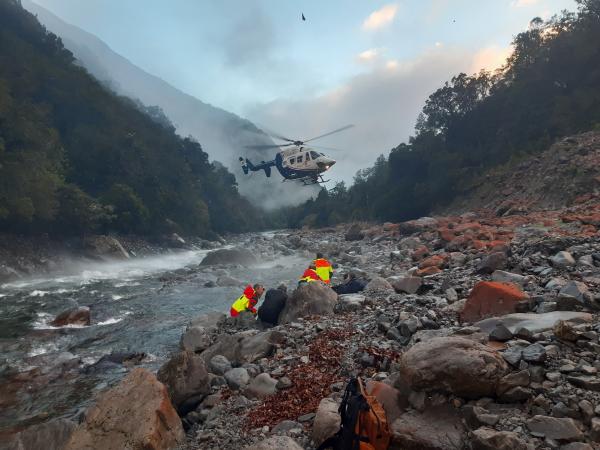 A helicopter arrives at Deception River in Westland to transport a rescued group to safety.
