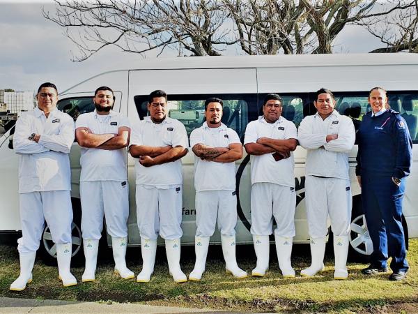 Senior Constable Chris Leppein with seasonal workers from Samoa who she's helping to get their NZ driver licence.