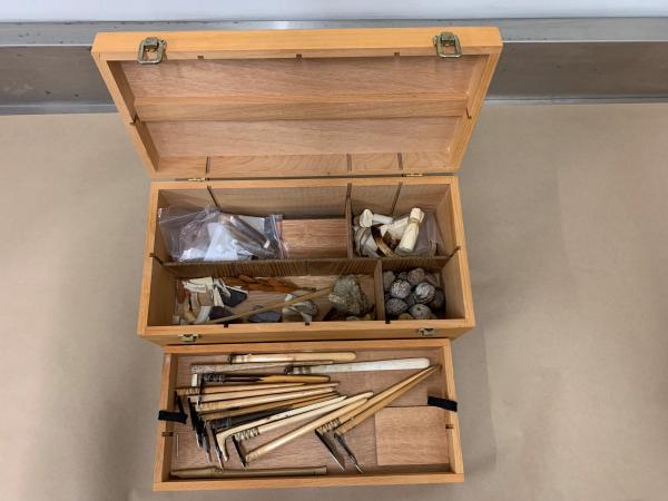 The hand-carved wood and bone uhi (tools).