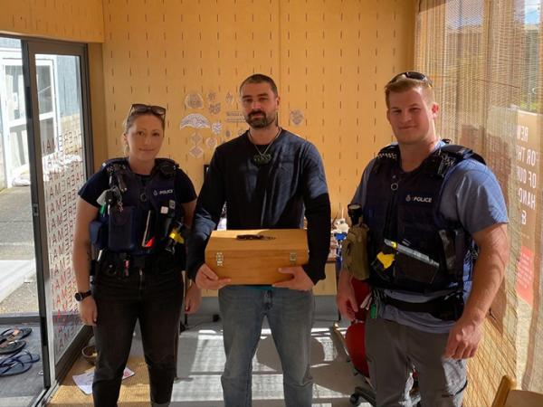 Constables Josh Downes and Jamie Allingham return Moko's tools.