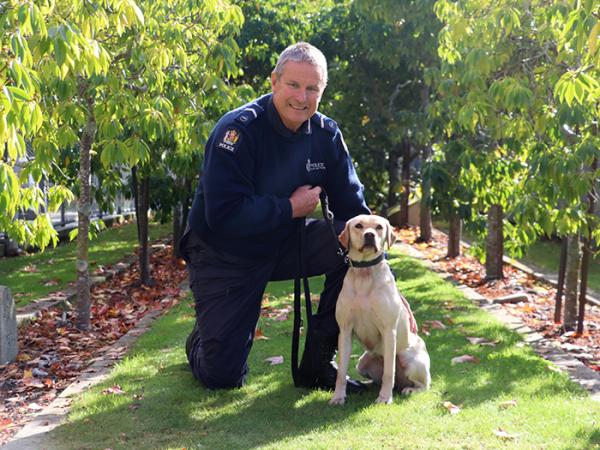 Senior Constable Grant Diver and his detector dog, Peyton.