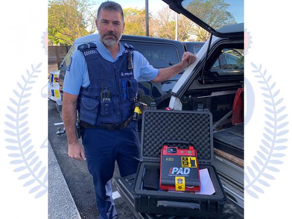 Senior Constable Brad Clark with the AED he used to save a man's life.