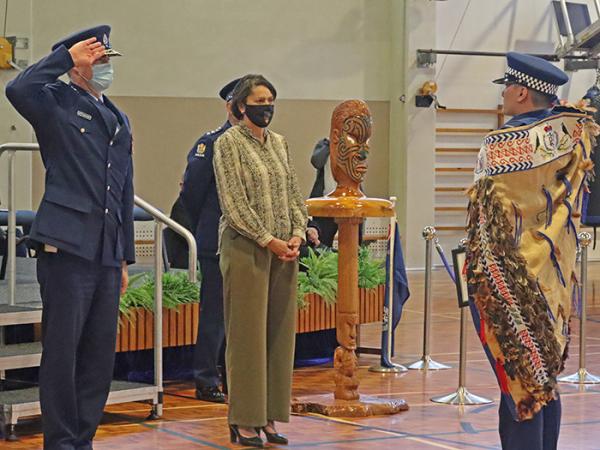 Commissioner Andrew Coster and Constable Peter You saluting.