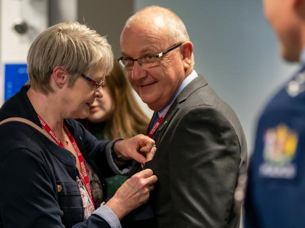 Former Inspector Olaf Jensen gets some last-minute adjustments from wife Jo. 
