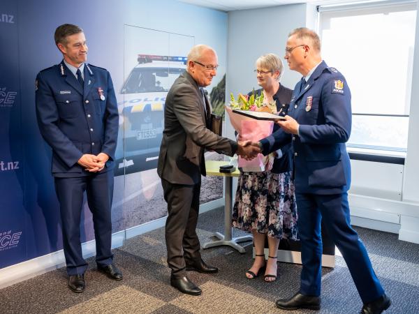 Commissioner Coster and Jo look on as Olaf receives his Certificate of Service from Southern District Commander Paul Basham.