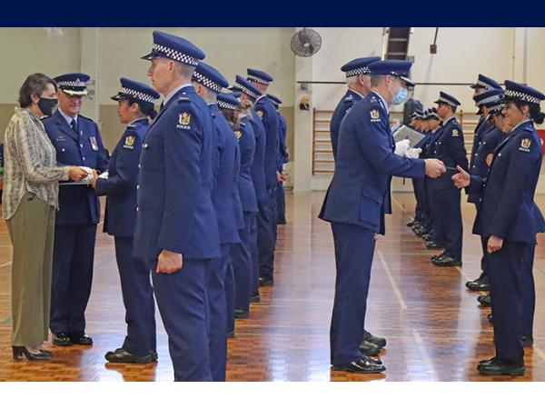 Minister of Police Poto Williams and Police Commissioner Andrew Coster presenting the graduates with their ID cards.